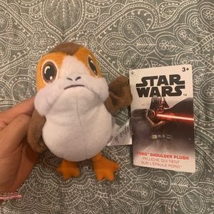 Porg sits on shoulder with magnet. Disney parks- shop Disney